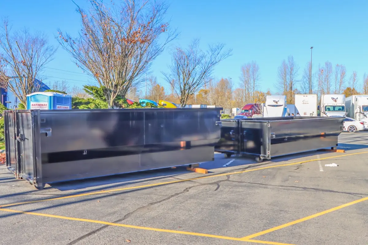 Professional dumpster rental service with roll-off container on residential driveway in Scituate